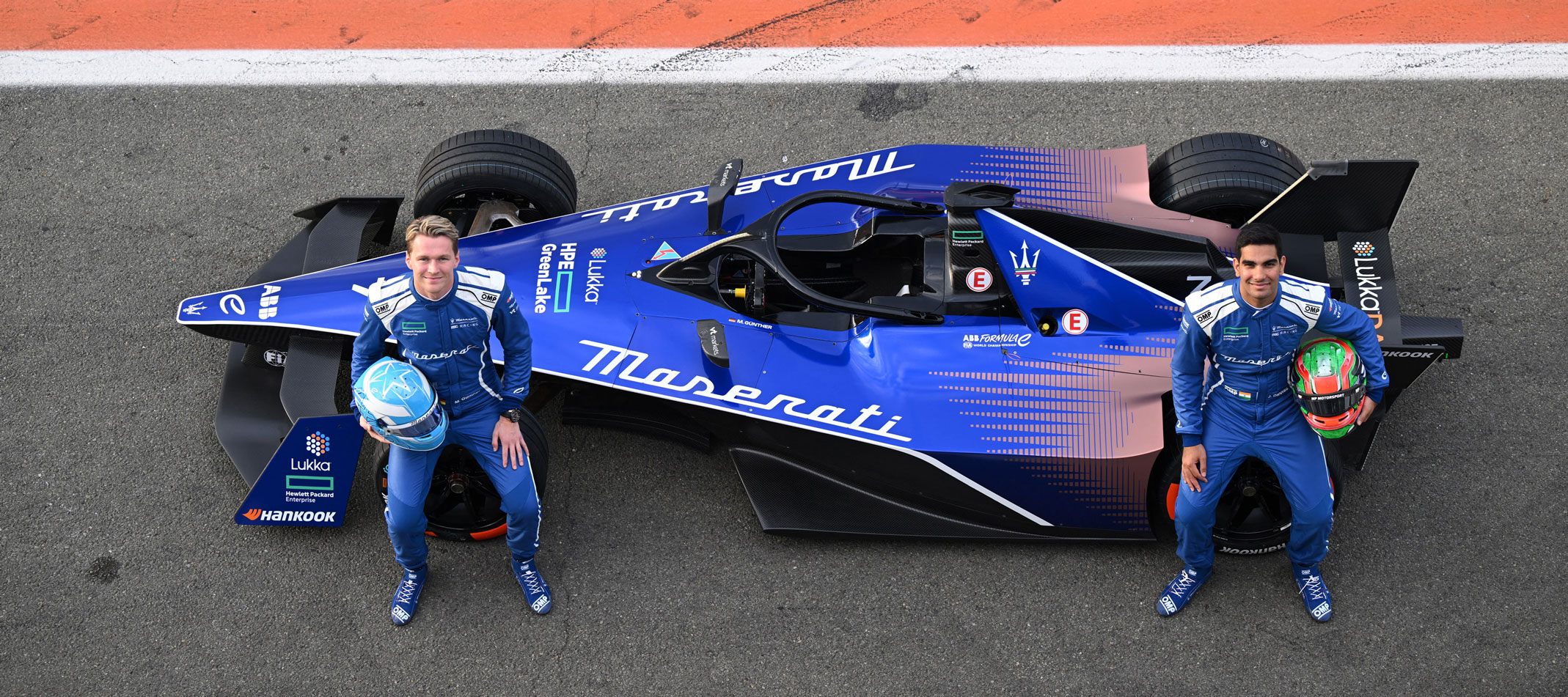 Maserati Pilots standing in front of Maserati formula E
